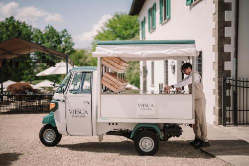 a man standing in a food cart at Viesca Toscana Suites & Villas in Reggello