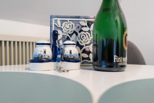 a bottle of wine sitting on a table next to a bottle at Klaus Lafrenz Petersdorf N°2 in Fehmarn