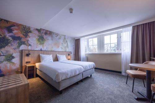 Postel nebo postele na pokoji v ubytování Fletcher Hotel-Restaurant Klein Zwitserland