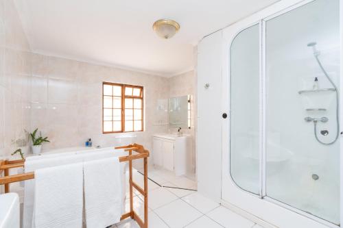 a bathroom with a shower and a tub and a sink at Montagu Little Sanctuary - Hot Spring Access at Special Rate in Montagu