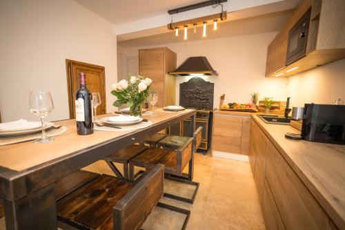 une cuisine avec une table avec une bouteille de vin dans l'établissement Maison Collobrieres, à Collobrières