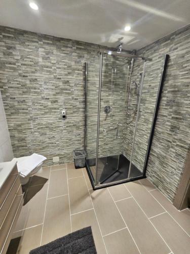 a bathroom with a shower with a glass door at HET Lounge in Radenthein