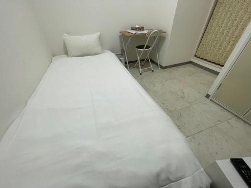 Ένα ή περισσότερα κρεβάτια σε δωμάτιο στο A&C STAY Shin-Osaka