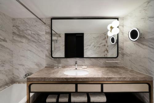 a bathroom with a sink and a mirror at Shangri-La Harbin in Harbin