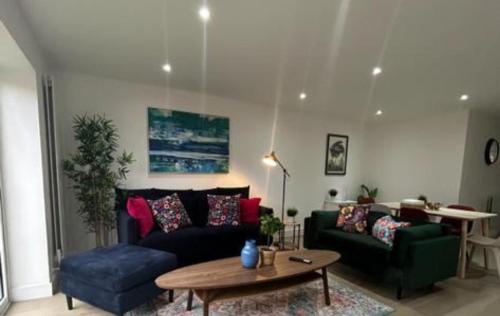 a living room with a couch and a table at London Mitcham Beautiful Three Bedroom House in Mitcham