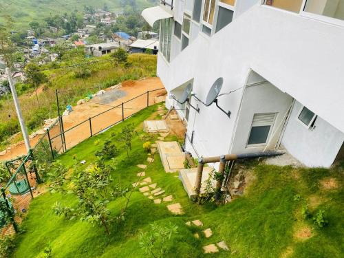 an aerial view of a white building with a yard at Wooton Peak Resort in Kotagala