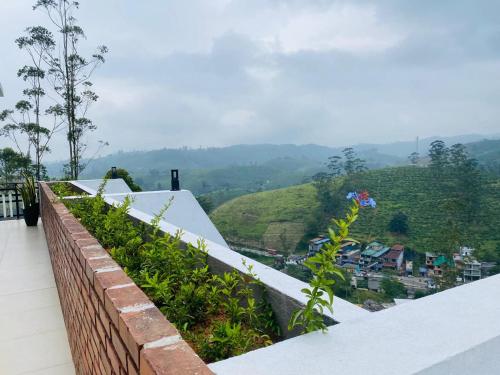 a balcony with a view of a mountain at Wooton Peak Resort in Kotagala