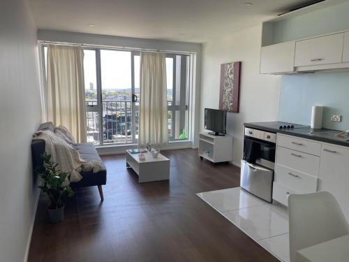 a kitchen and living room with a view of a city at Auckland city central apartment 2 bedrooms apartment Wi-Fi balcony harbor or skytower view near public parking 1204 in Auckland