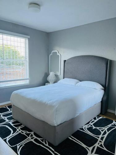 a bedroom with a large white bed and a window at Anga Spaces in Witbank