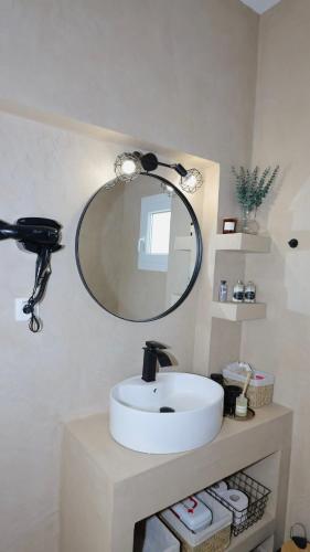 a bathroom with a white sink and a mirror at V la vie in Ioannina