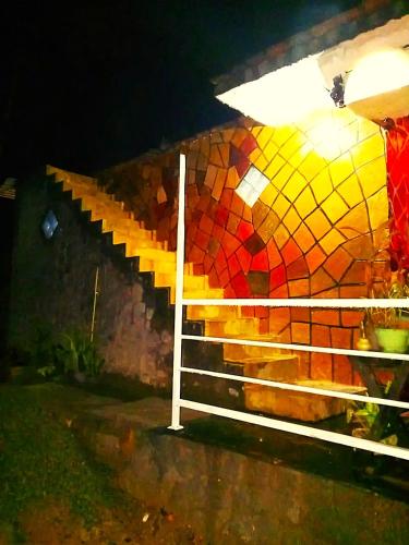 a set of stairs with a mosaic tile wall at Off grid Ella Homestay in Ella