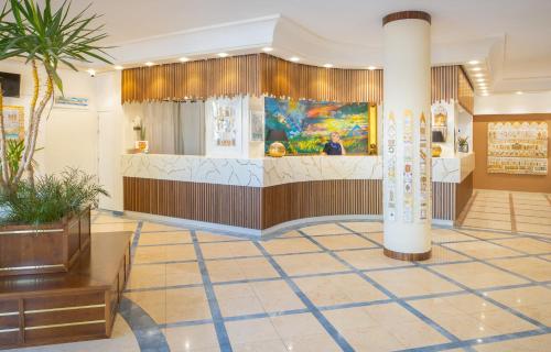 a lobby of a store with a reception counter at Hotel Kalura in Cefalù