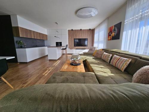 a living room with a couch and a table at Moderný apartmán s terasou in Prievidza