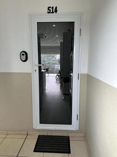 a room with a door with a view of a hallway at Umdloti Holiday Resort Apartment 514 - Amazing Breaker & Ocean Views in Umdloti