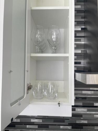 a cupboard with wine glasses sitting in it at Giftly Surprize in Kimberley