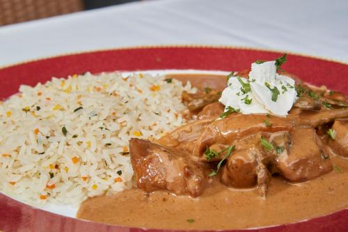 a plate of food with rice and meat at Parkhotel Schwert in Weesen