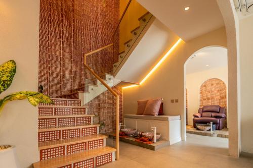 a staircase in a home with a brick wall at The Fig Lobby Bangkok in Bangkok