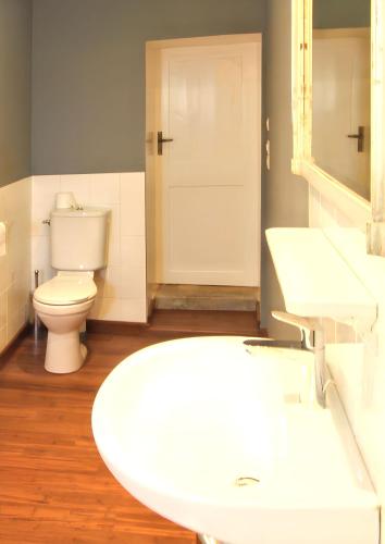 une salle de bain avec un lavabo blanc et des toilettes dans l'établissement Maison charmante à Ryes avec jardin clos et accès PMR, à Ryes