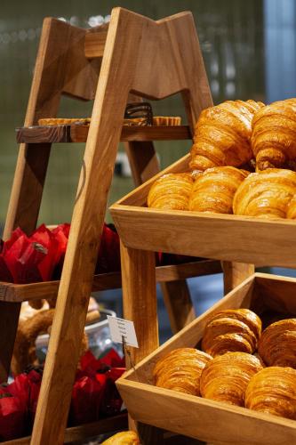 a display of baskets of pastries on a shelf at Almaty Hotel in Almaty