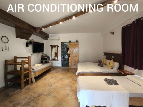 a room with two beds in it with the words air conditioning room at Sulu Sunset Beach Resort in Nauhang