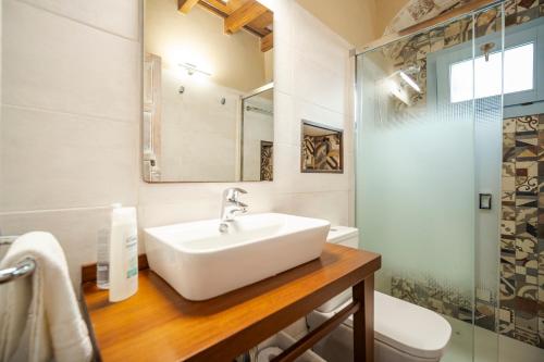 a bathroom with a sink and a toilet and a shower at La Sultana de Vejer in Vejer de la Frontera