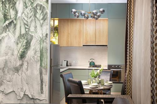 a kitchen and dining room with a table and chairs at Apartment & Parking "Opera at the corner" in Odesa