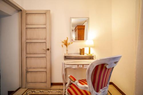 a room with a table and a mirror and a chair at La Sultana de Vejer in Vejer de la Frontera