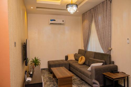 a living room with a couch and a table at Number Ten by Scarborough - Luxury Serviced Apartments, Asaba in Asaba