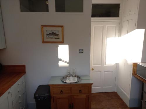 a kitchen with a table with a glass bowl on it at Large Bright Soho Studio flat with Large Terrace in London