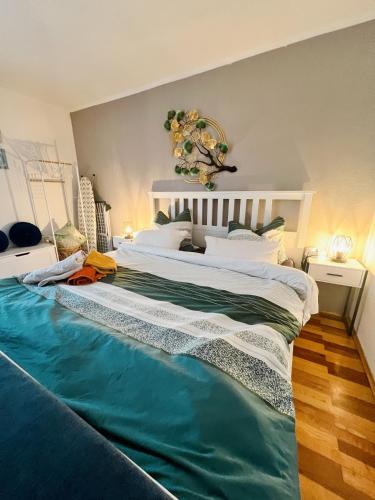 a bedroom with a large bed with a blue blanket on it at Gemütlicher Raum, Gampern in Gampern
