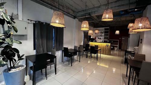 a dining room with tables and chairs and lights at Coco Mountain View Guest House Hotel in Kata Beach