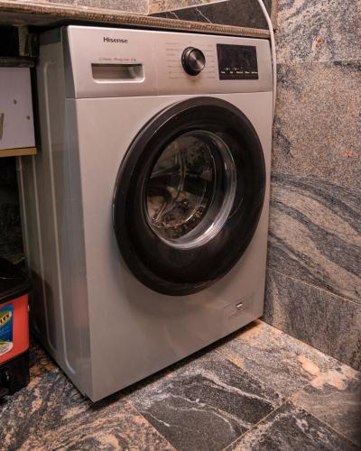 a washing machine with its door open on a counter at Number Ten by Scarborough - Luxury Serviced Apartments, Asaba in Asaba