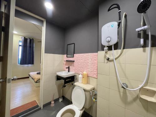 a bathroom with a toilet and a sink and a shower at NR Cyber1 Homestay in Cyberjaya