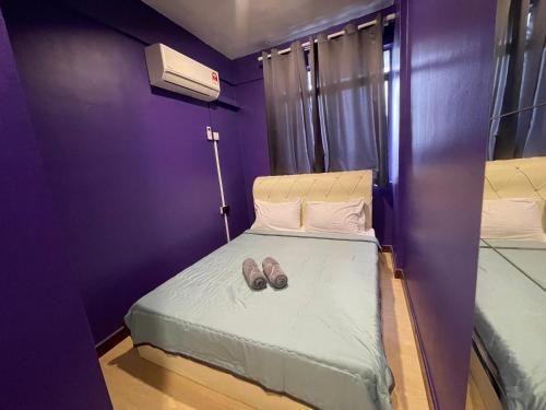 a pair of shoes sitting on a bed in a room at NR Cyber1 Homestay in Cyberjaya