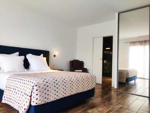 a bedroom with a bed with a red and white blanket at Le Roc E Fiori Hotel - Teritoria in Porto-Vecchio