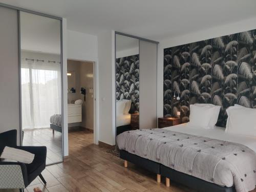a bedroom with a large bed with a wall mural at Le Roc E Fiori Hotel - Teritoria in Porto-Vecchio