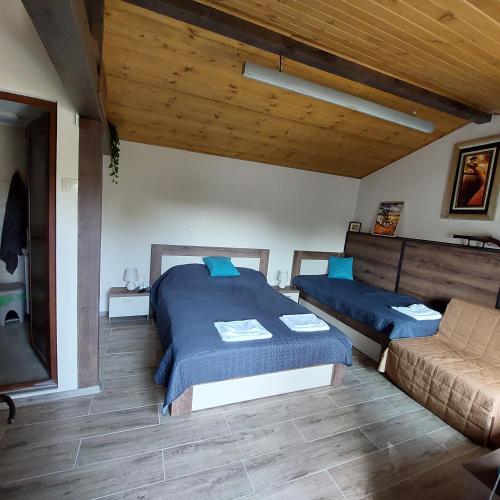 a bedroom with two beds and a couch at Коларова къща in Avren