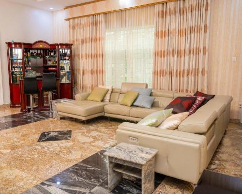 a living room with a couch and a table at Number Ten by Scarborough - Luxury Serviced Apartments, Asaba in Asaba