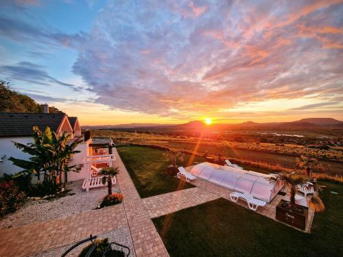 an aerial view of a sunset with the sun setting at ARDO Élménybirtok in Balatonederics