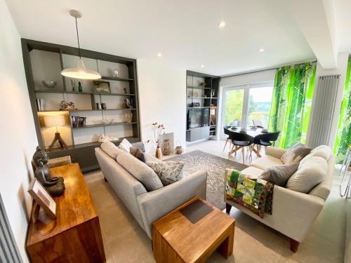 a living room with a couch and a table at Rare & Breathtaking View With Secret Garden Bar in Horsforth