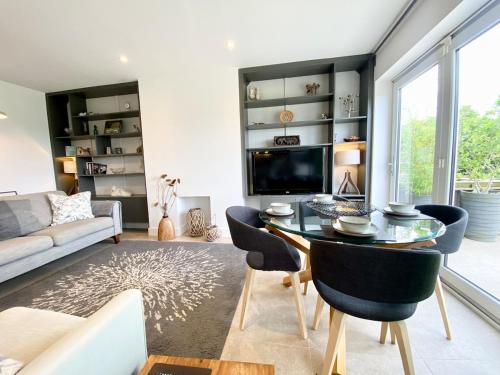 a living room with a table and chairs and a couch at Rare & Breathtaking View With Secret Garden Bar in Horsforth