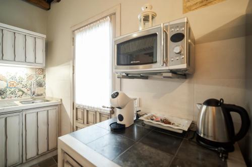 a kitchen with a microwave above a kitchen counter at La Sultana de Vejer in Vejer de la Frontera