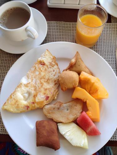 a plate of breakfast food with a cup of coffee at SILVER SLOPES RESORT AND SPA in Kagio