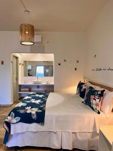 a bedroom with a bed with a sink and a mirror at Flat's Maravista Beiramar in São Miguel do Gostoso