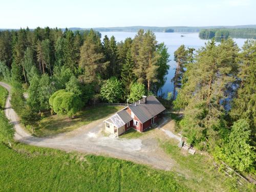 an aerial view of a house on a hill next to a lake at Kaijansaaren Lomamökit in Tölvä