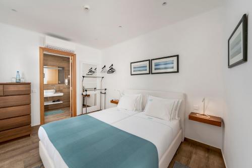 a bedroom with a large bed and a bathroom at AL-Odeceixe Verde in Odeceixe