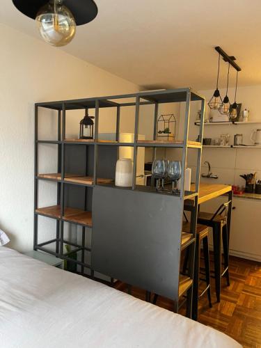 a room with a table and a shelf with glasses at Comodo monoambiente bien ubicado en Cordon in Montevideo