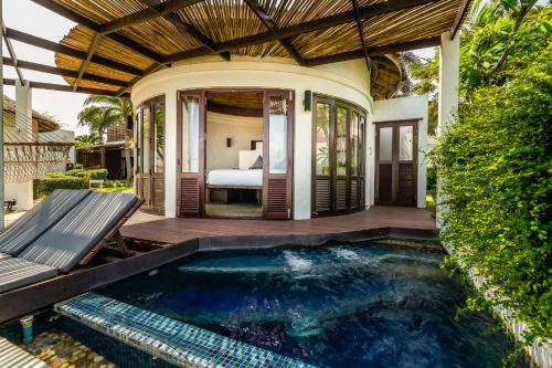 a pool in the backyard of a villa at Aleenta Hua Hin - Pranburi - The Small Luxury Hotels of the World in Pran Buri