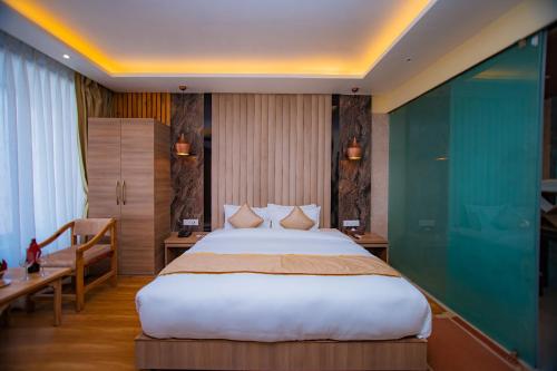 a hotel room with a large bed and a desk at Temple Himalaya Hotel & Spa in Pokhara