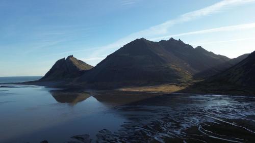 a view of a mountain range with a body of water at House in Fjörður in Lón South East of Iceland - Birta Rentals in Höfn